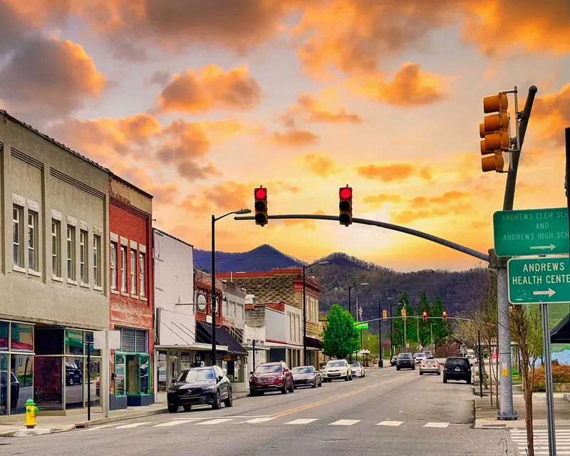 Downtown Andrews, North Carolina main street with mountains at sunset