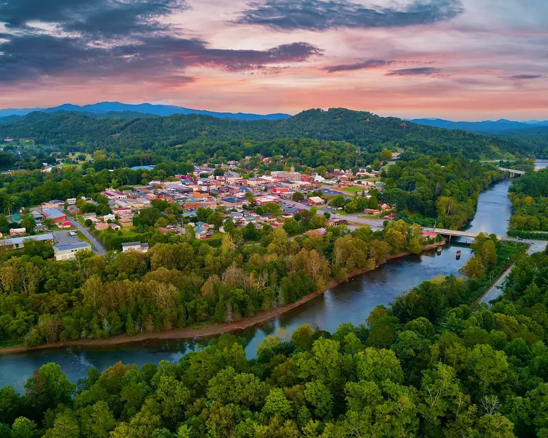 Aerial view of downtown Murphy, North Carolina beside the Hiwassee River at sunset